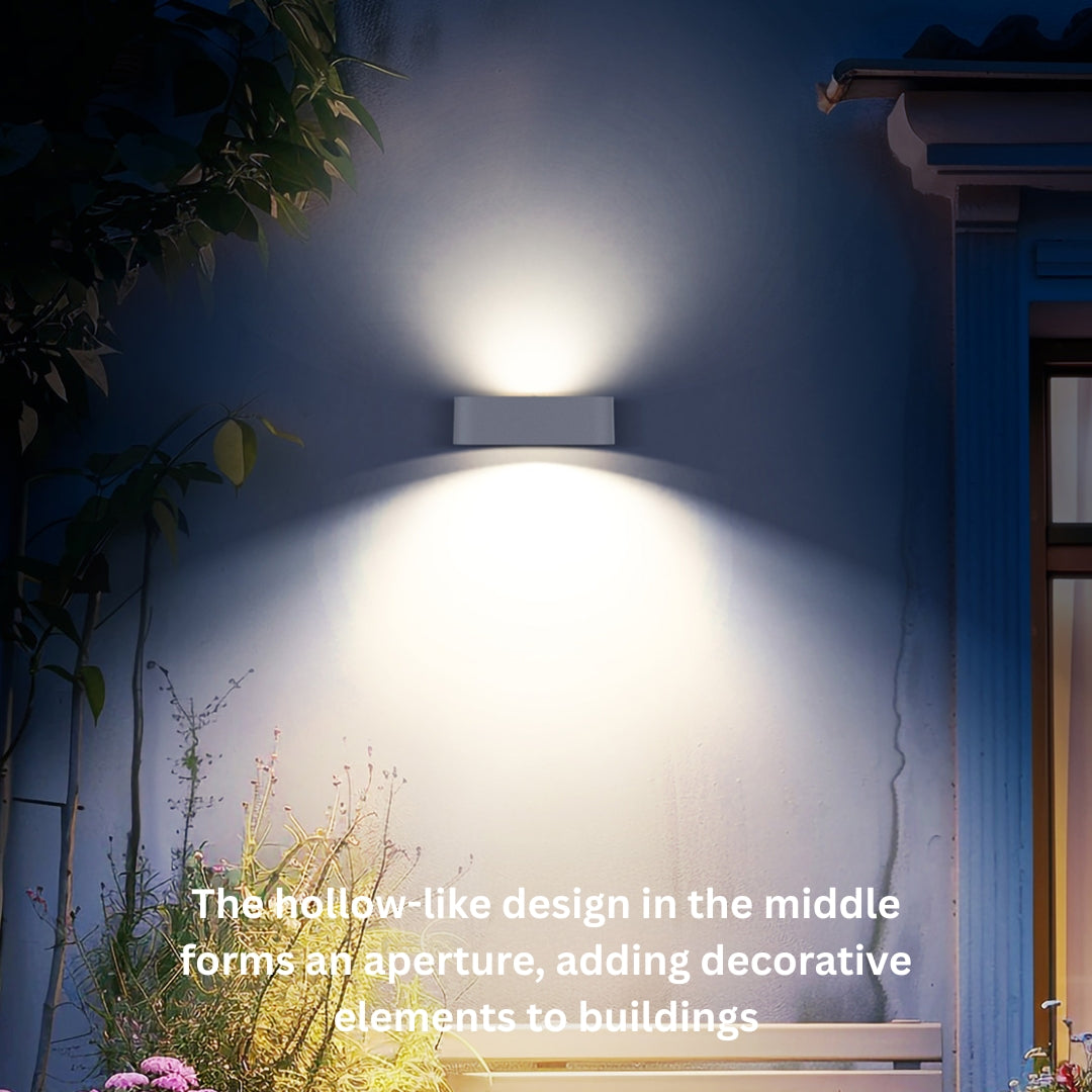 Wall mounted outdoor solar up down  light fixture on a building exterior with decorative elements.