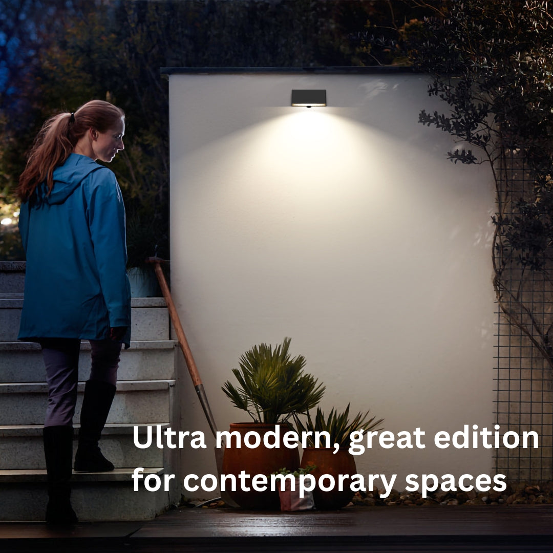 Person standing on steps near a wall-mounted solar light fixture with text overlay.